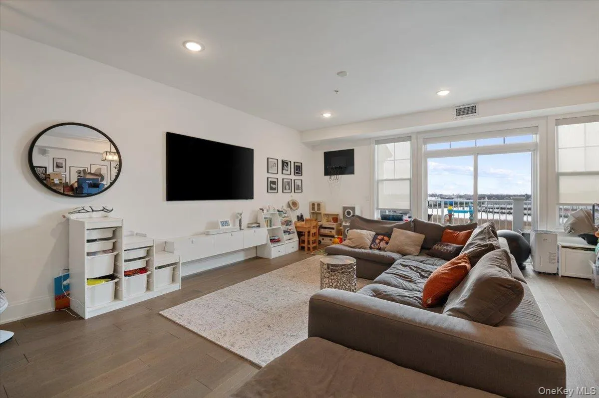 Living room featuring wood-type flooring and recessed lighting Living room featuring wood-type flooring and recessed lighting