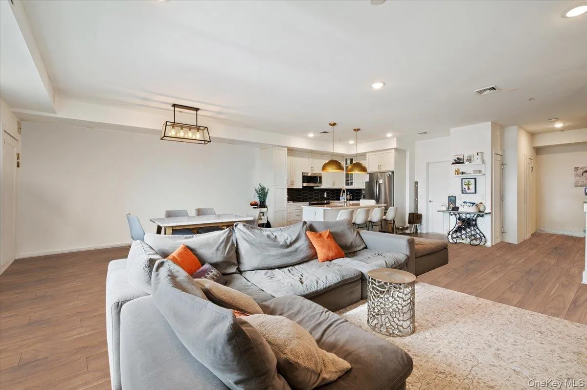 Living area featuring light wood-type flooring and recessed lighting Living area featuring light wood-type flooring and recessed lighting