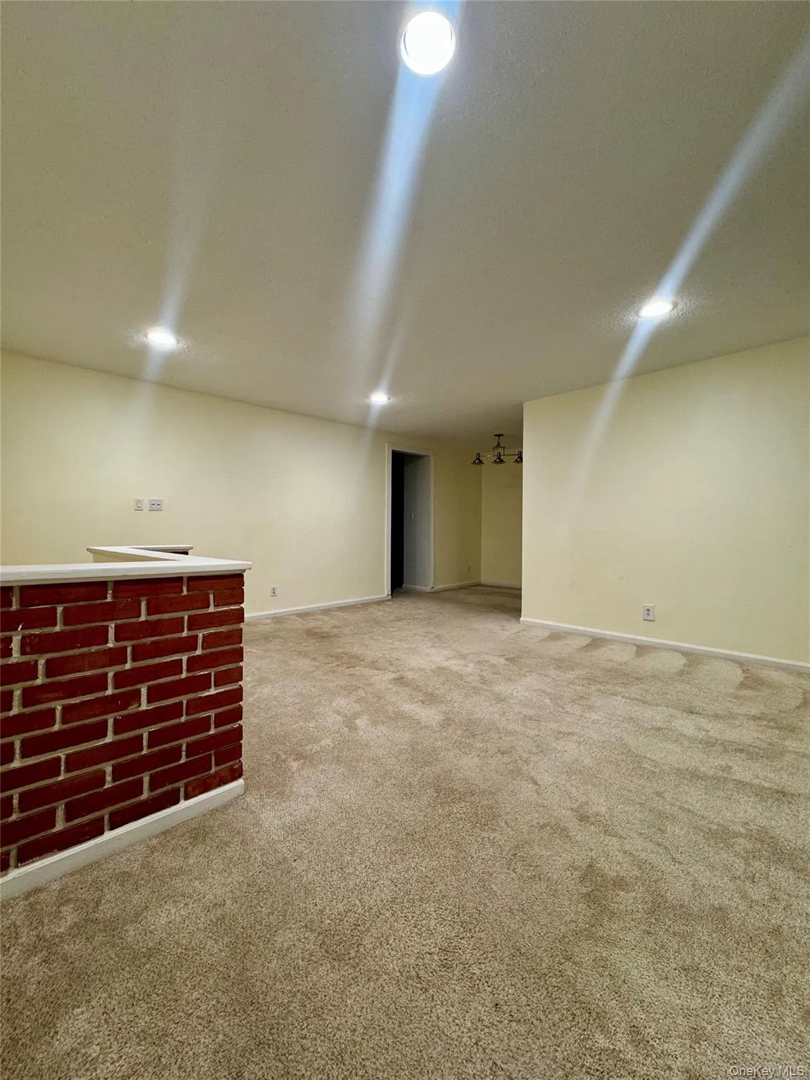 Below grade area featuring light colored carpet and recessed lighting Below grade area featuring light colored carpet and recessed lighting