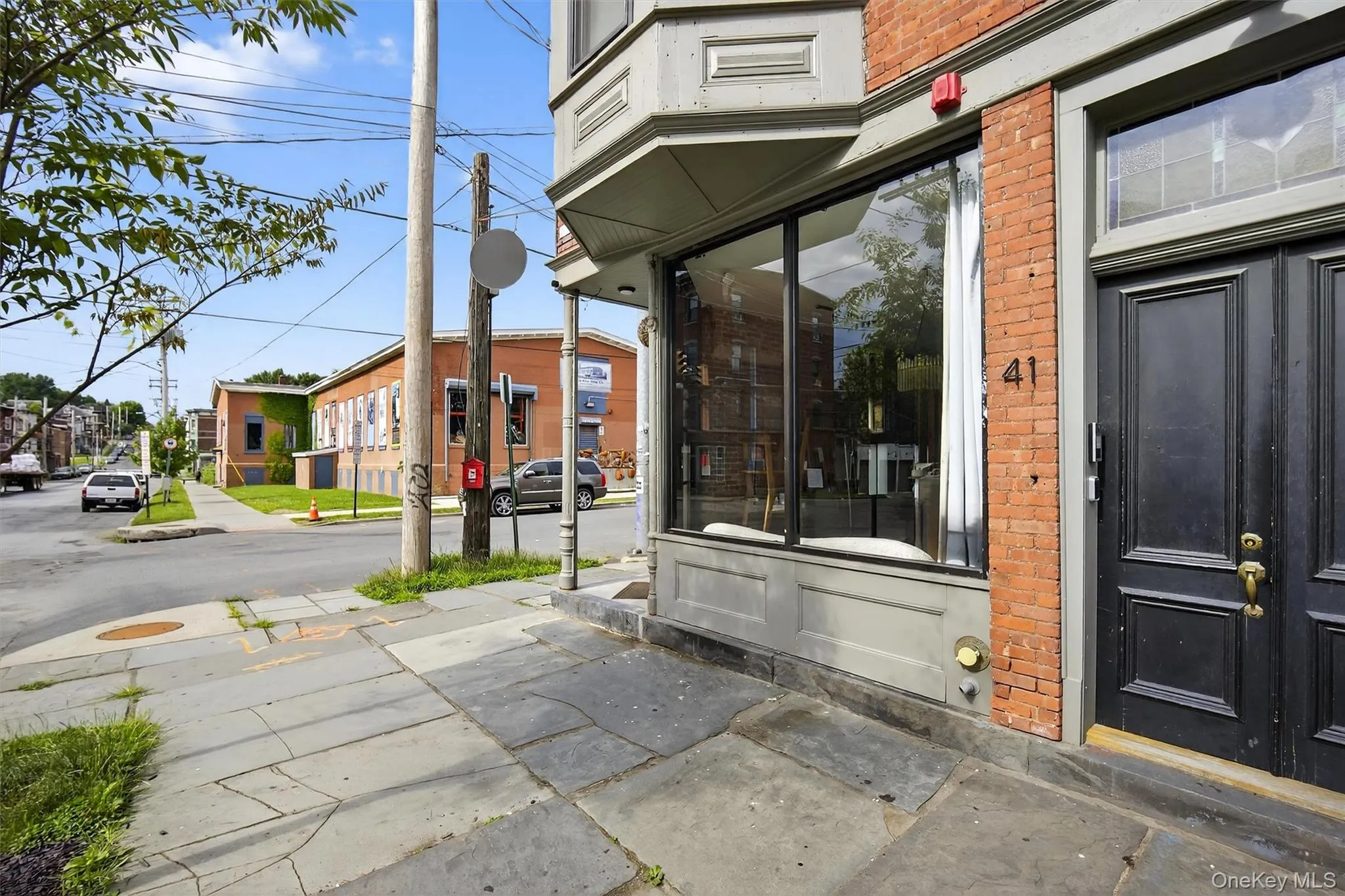 Entrance to property featuring brick siding and a residential view Entrance to property featuring brick siding and a residential view