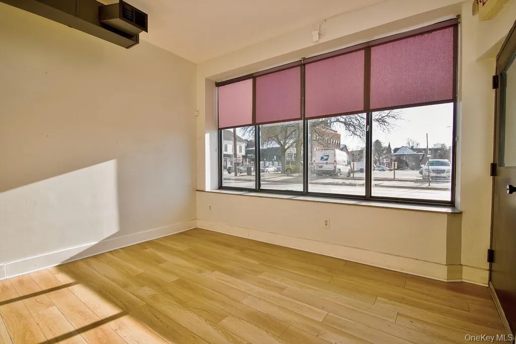 Empty room with light wood-type flooring and baseboards Empty room with light wood-type flooring and baseboards