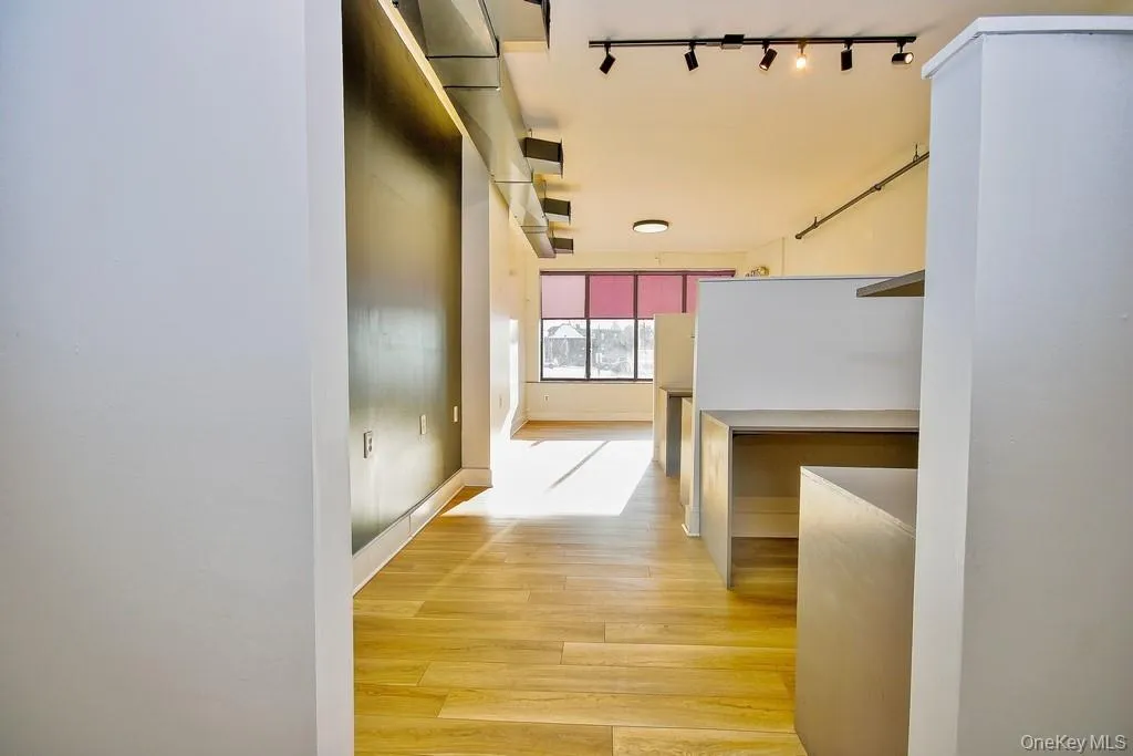 Hallway featuring light wood finished floors Hallway featuring light wood finished floors