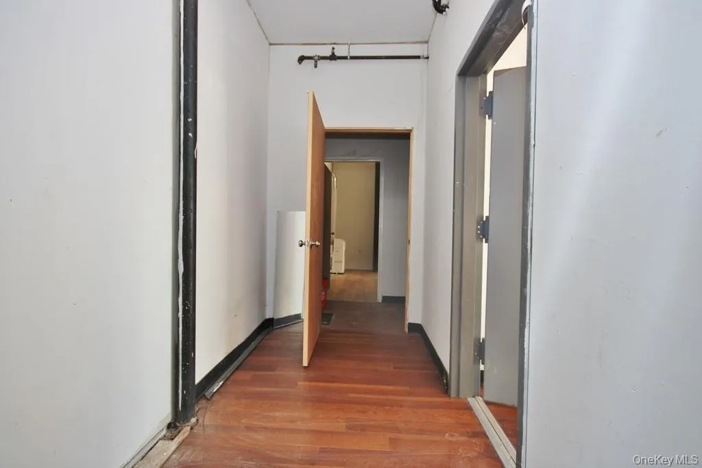Hallway featuring dark wood finished floors Hallway featuring dark wood finished floors