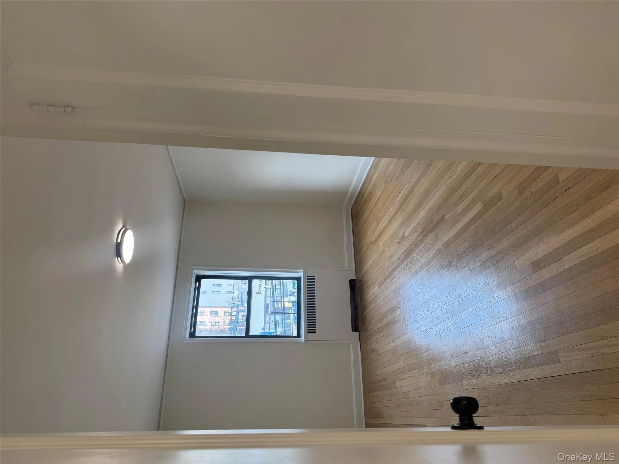 Spare room featuring radiator and light wood-style floors Spare room featuring radiator and light wood-style floors