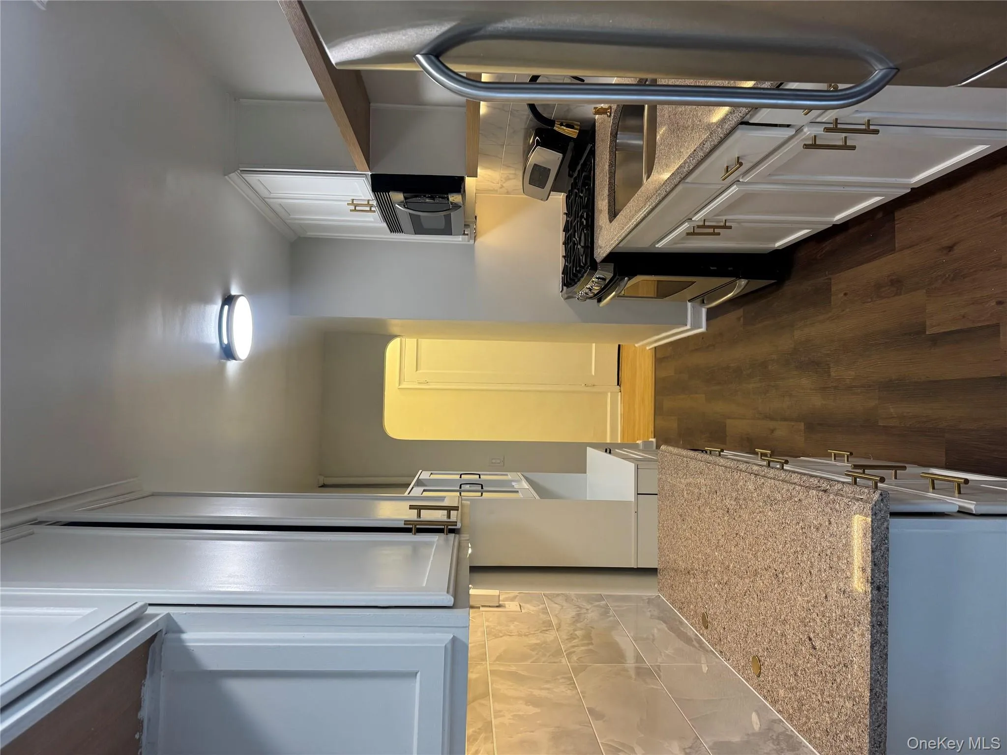 Kitchen featuring tasteful backsplash, range, stainless steel refrigerator, and light stone counters Kitchen featuring tasteful backsplash, range, stainless steel refrigerator, and light stone counters