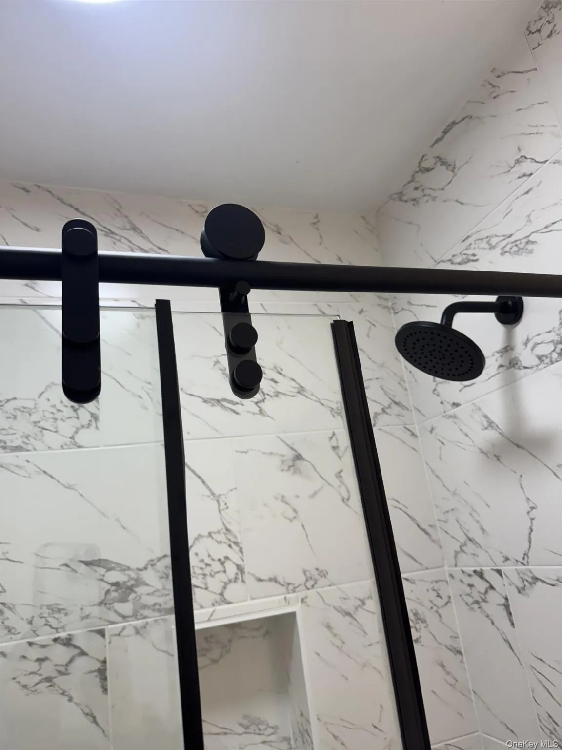 Bathroom view of a marble finish shower Bathroom view of a marble finish shower