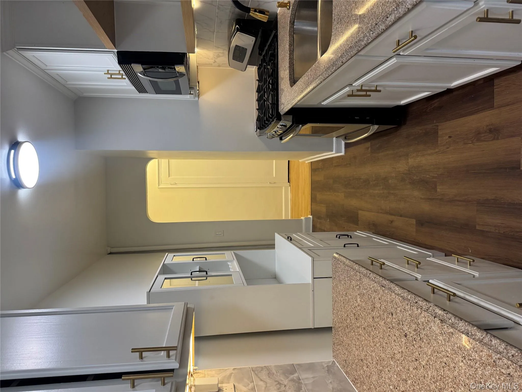 Kitchen featuring tasteful backsplash, arched walkways, stainless steel stove, open shelves, and white cabinets Kitchen featuring tasteful backsplash, arched walkways, stainless steel stove, open shelves, and white cabinets