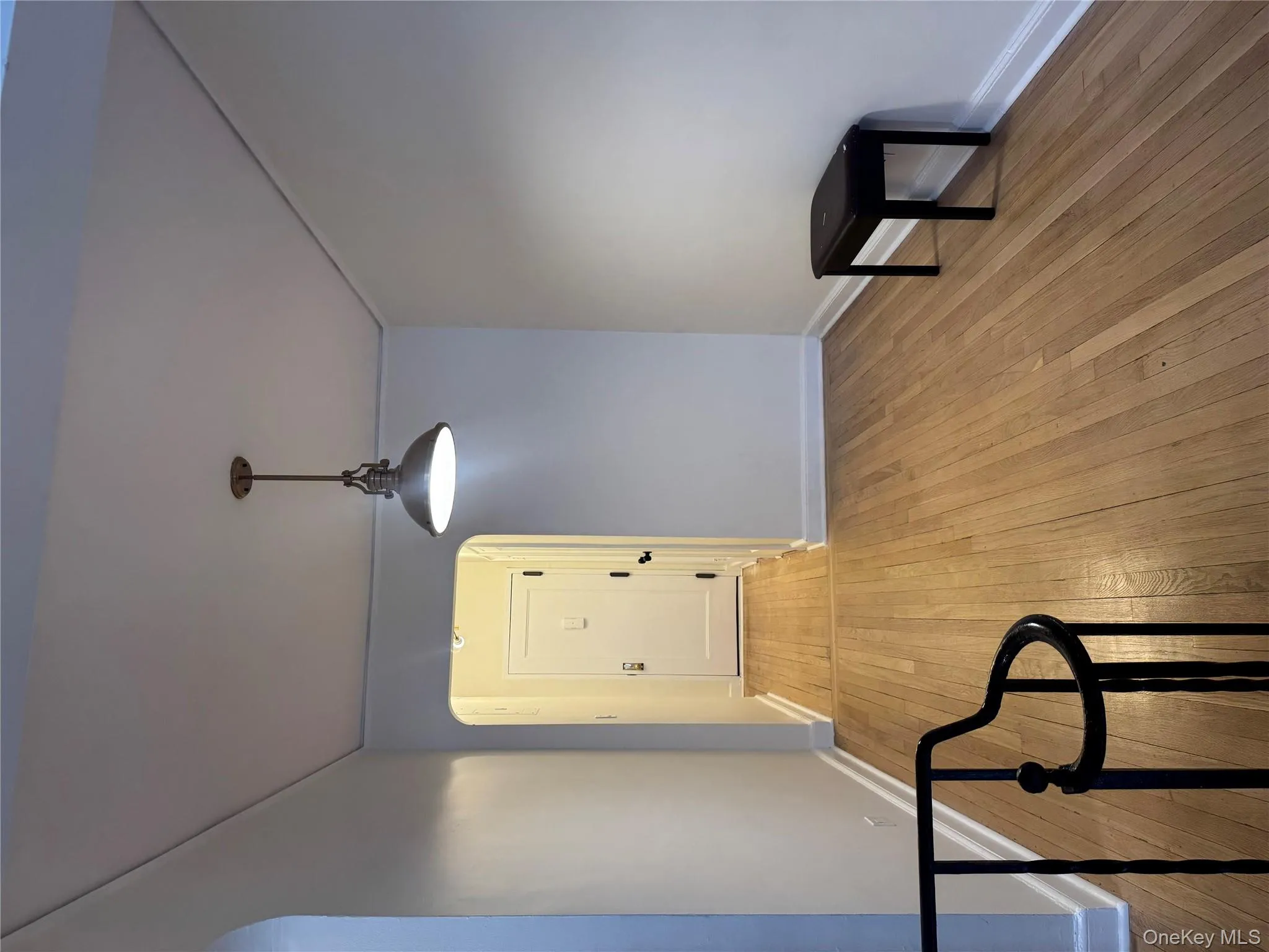 Unfurnished dining area featuring arched walkways and light wood-type flooring Unfurnished dining area featuring arched walkways and light wood-type flooring