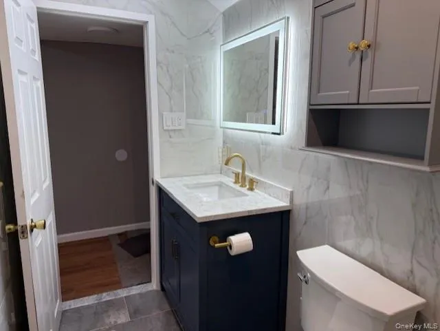 Bathroom with tile walls and vanity Bathroom with tile walls and vanity