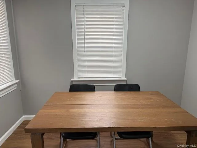 Dining space featuring baseboards and dark wood finished floors Dining space featuring baseboards and dark wood finished floors