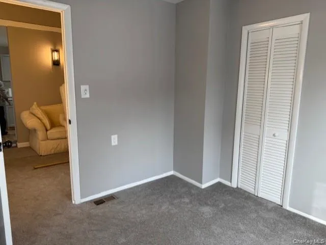 Unfurnished bedroom featuring carpet floors and a closet Unfurnished bedroom featuring carpet floors and a closet