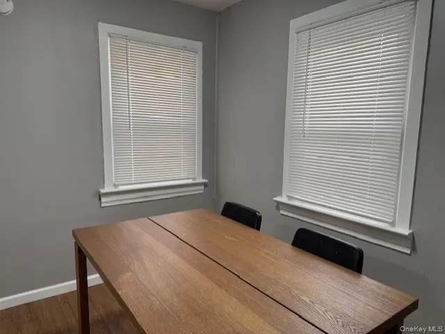 Dining room with baseboards and dark wood-type flooring Dining room with baseboards and dark wood-type flooring