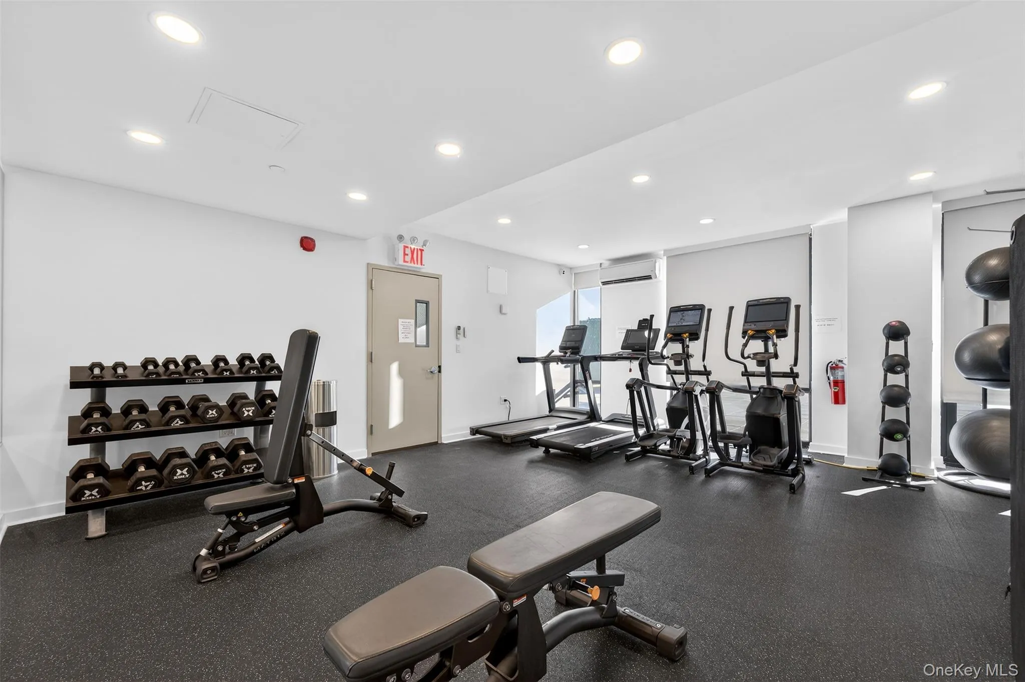 Workout area featuring recessed lighting and a wall mounted air conditioner Workout area featuring recessed lighting and a wall mounted air conditioner