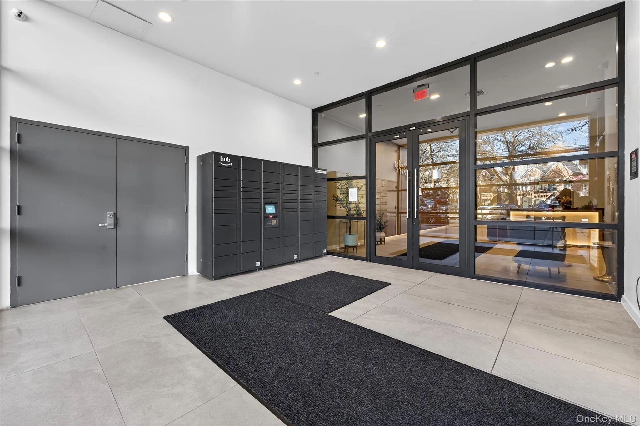 Common area with expansive windows, a high ceiling, and recessed lighting Common area with expansive windows, a high ceiling, and recessed lighting