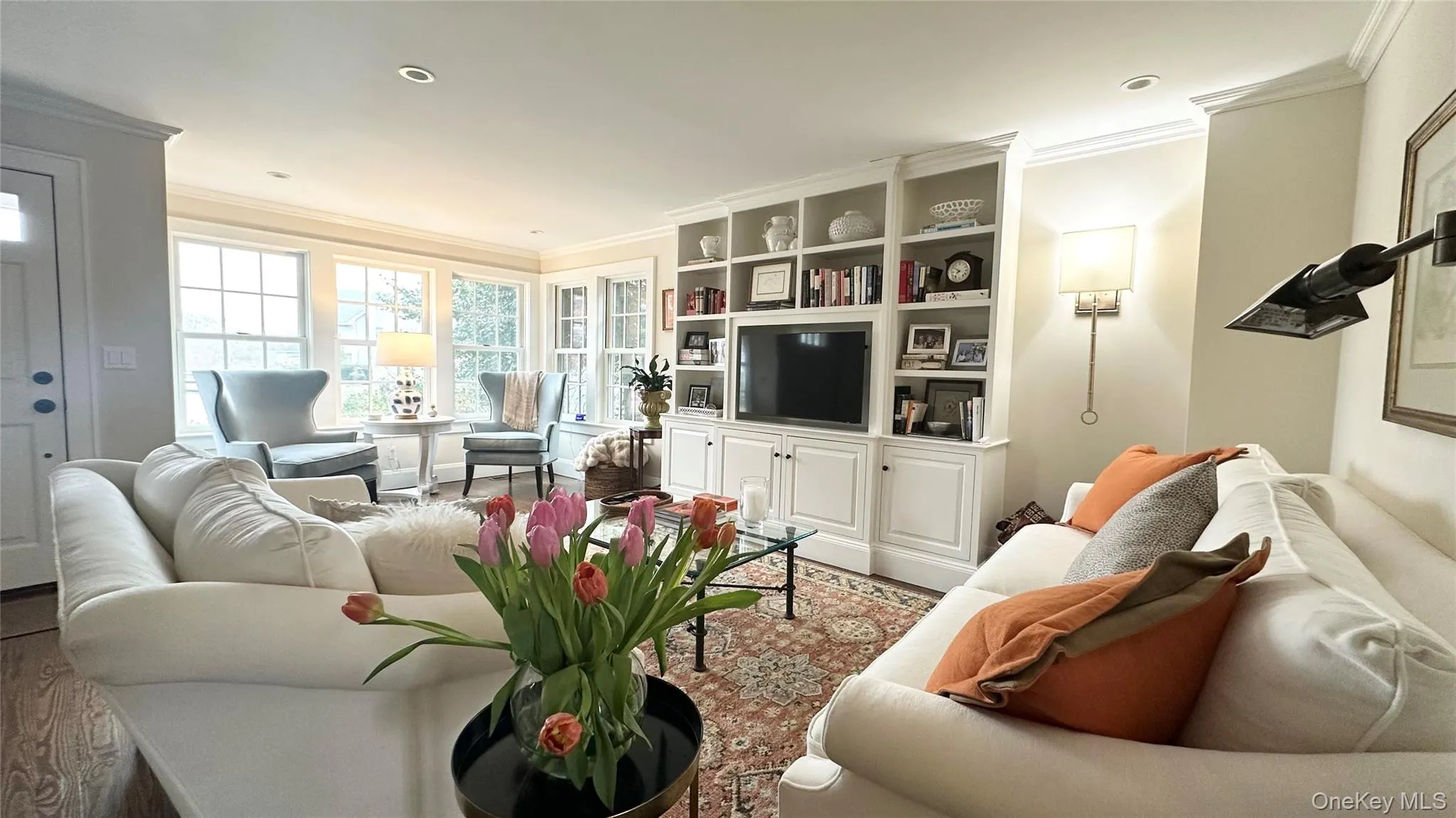 Living room with hardwood / wood-style floors and crown molding Living room with hardwood / wood-style floors and crown molding