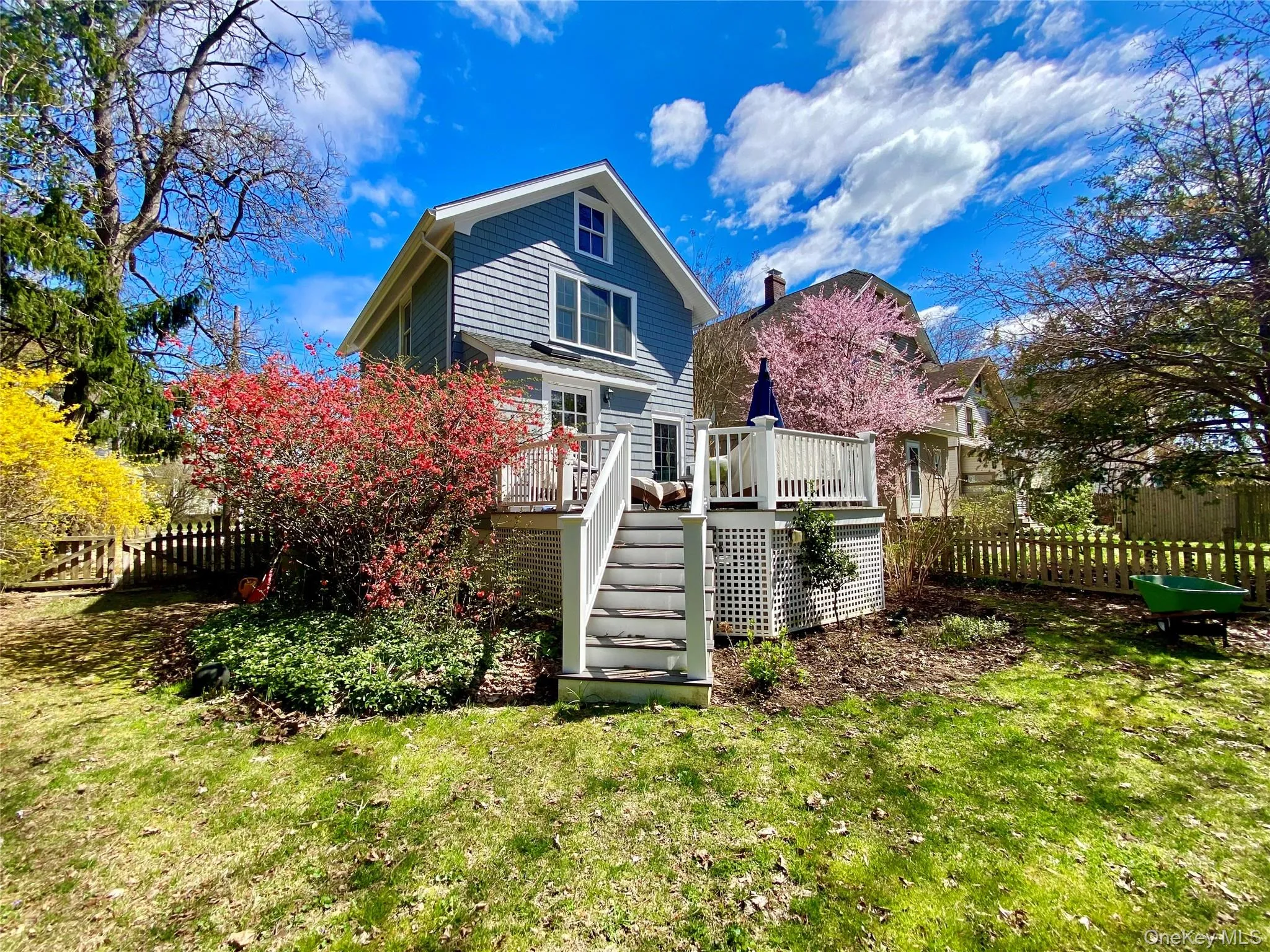 Back of house featuring a deck and a lawn Back of house featuring a deck and a lawn
