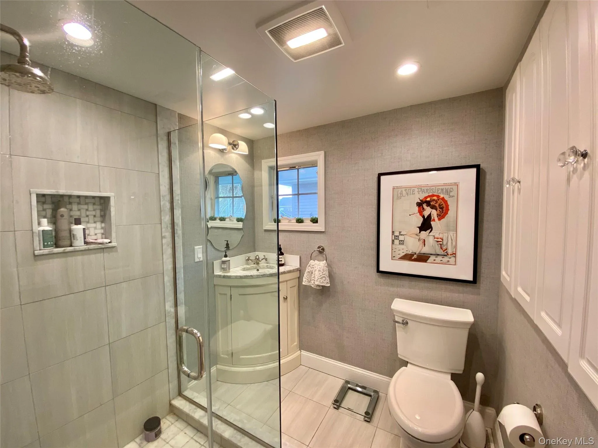 Bathroom with tile patterned flooring, vanity, toilet, and walk in shower Bathroom with tile patterned flooring, vanity, toilet, and walk in shower