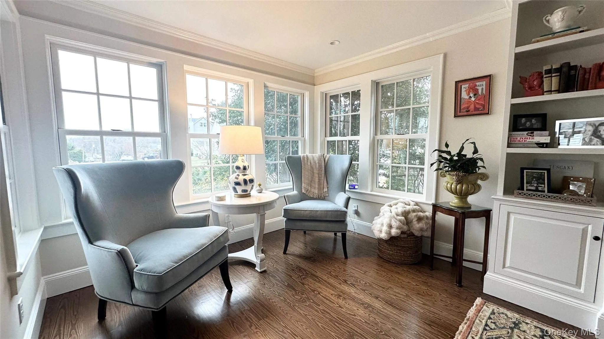 Sitting room with a healthy amount of sunlight, crown molding, and dark wood-type flooring Sitting room with a healthy amount of sunlight, crown molding, and dark wood-type flooring