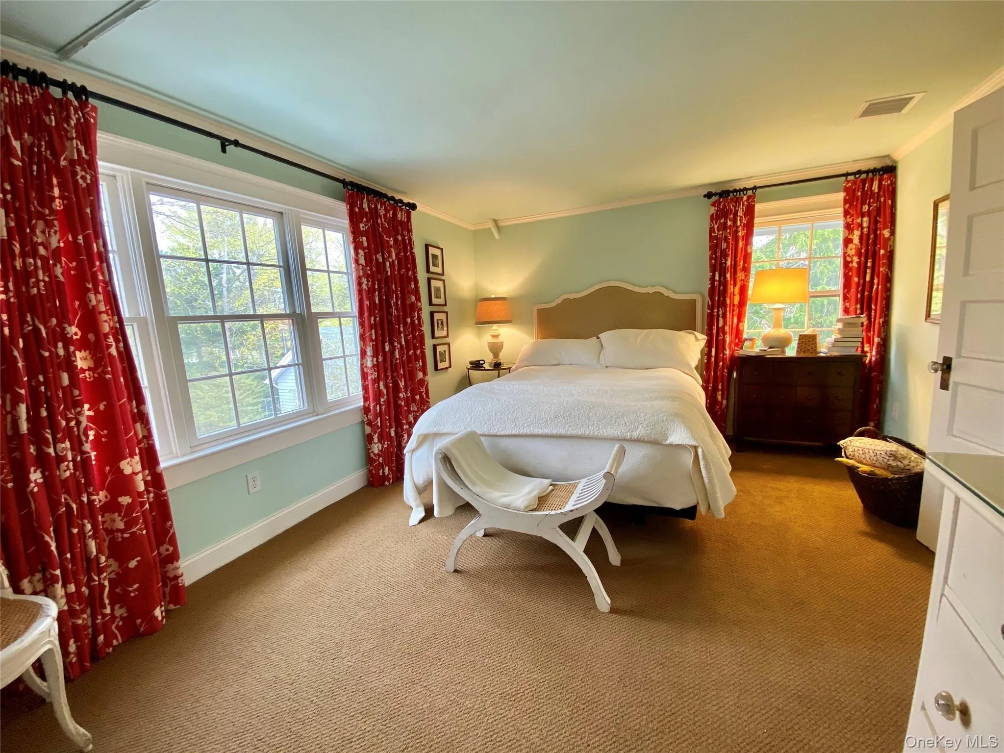 Carpeted bedroom featuring ornamental molding Carpeted bedroom featuring ornamental molding