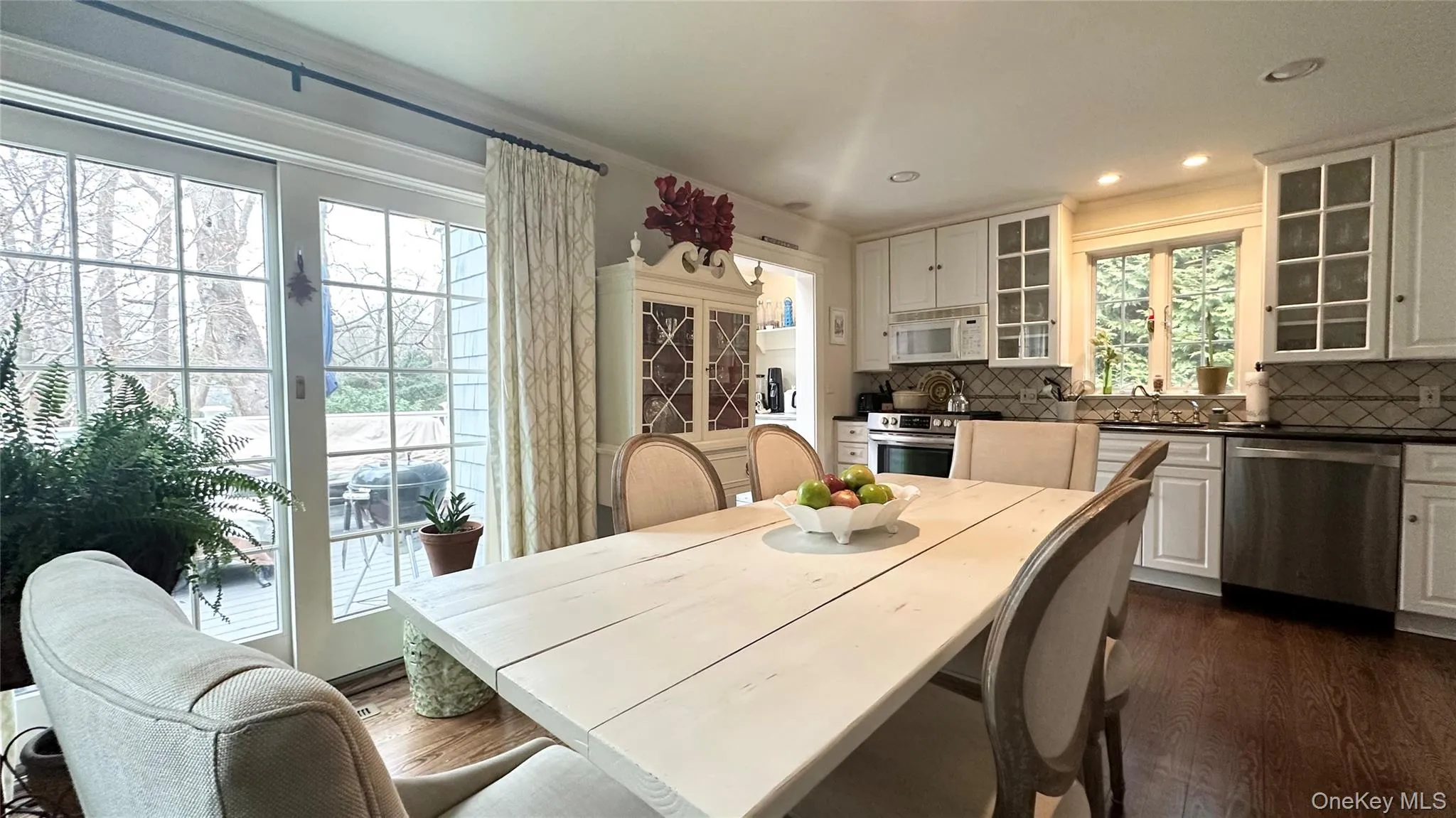 Dining area with dark hardwood / wood-style floors, a healthy amount of sunlight, and sink Dining area with dark hardwood / wood-style floors, a healthy amount of sunlight, and sink