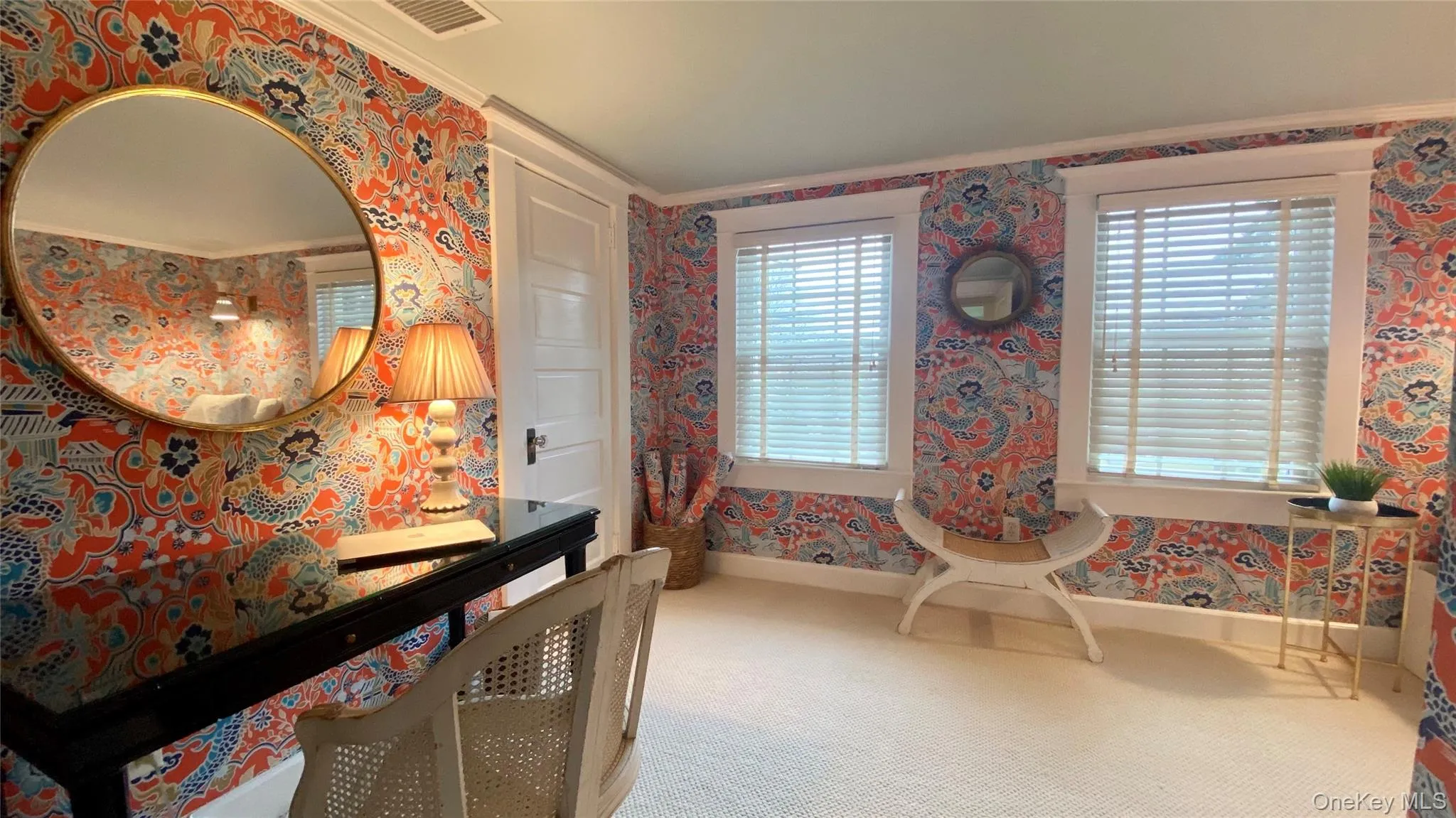 Carpeted bedroom featuring multiple windows and crown molding Carpeted bedroom featuring multiple windows and crown molding