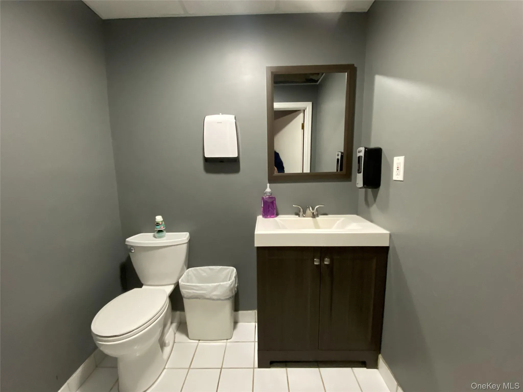 Bathroom featuring vanity and light tile patterned flooring Bathroom featuring vanity and light tile patterned flooring