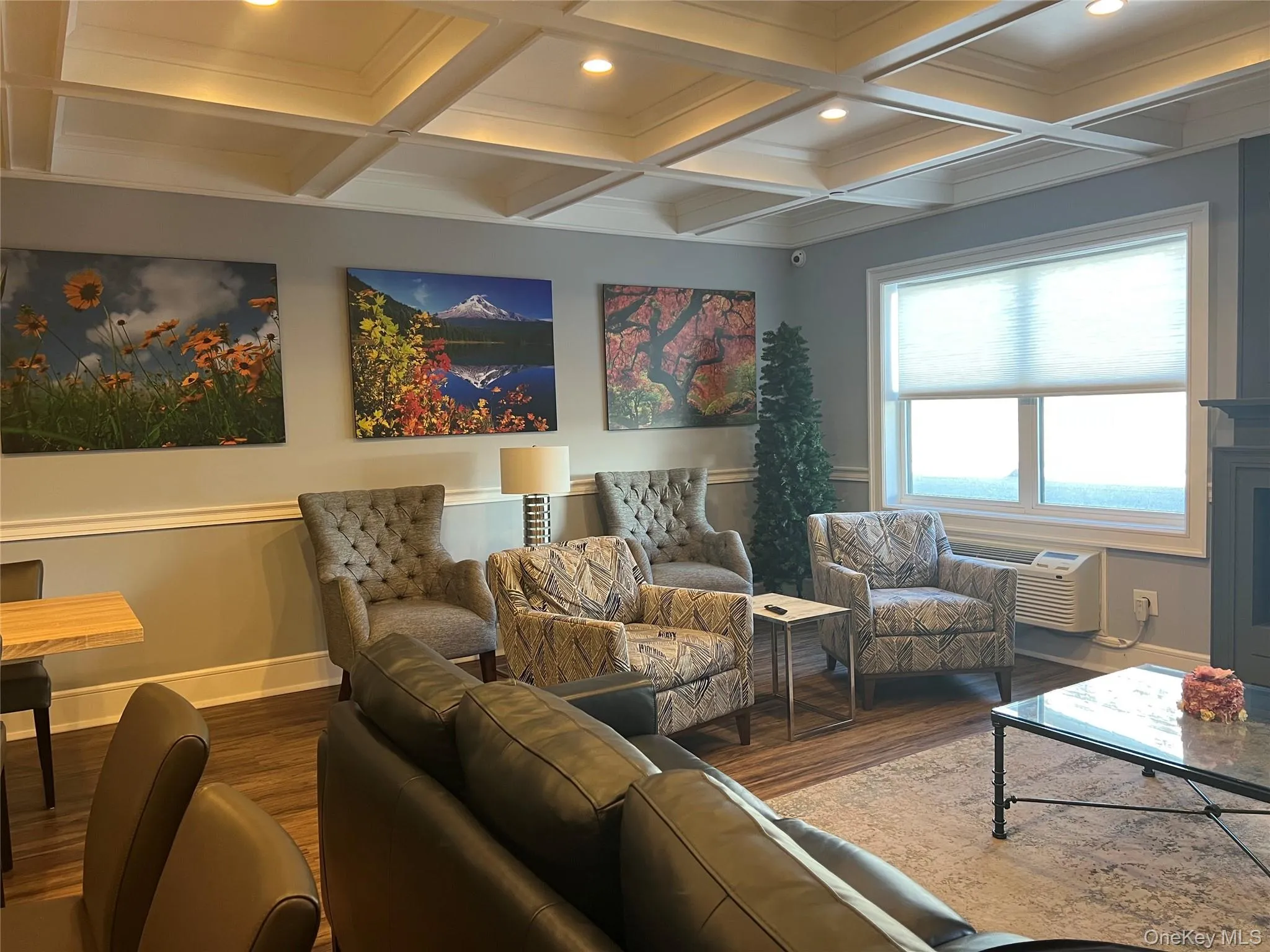 Living area featuring coffered ceiling, beam ceiling, recessed lighting, and wood finished floors Living area featuring coffered ceiling, beam ceiling, recessed lighting, and wood finished floors