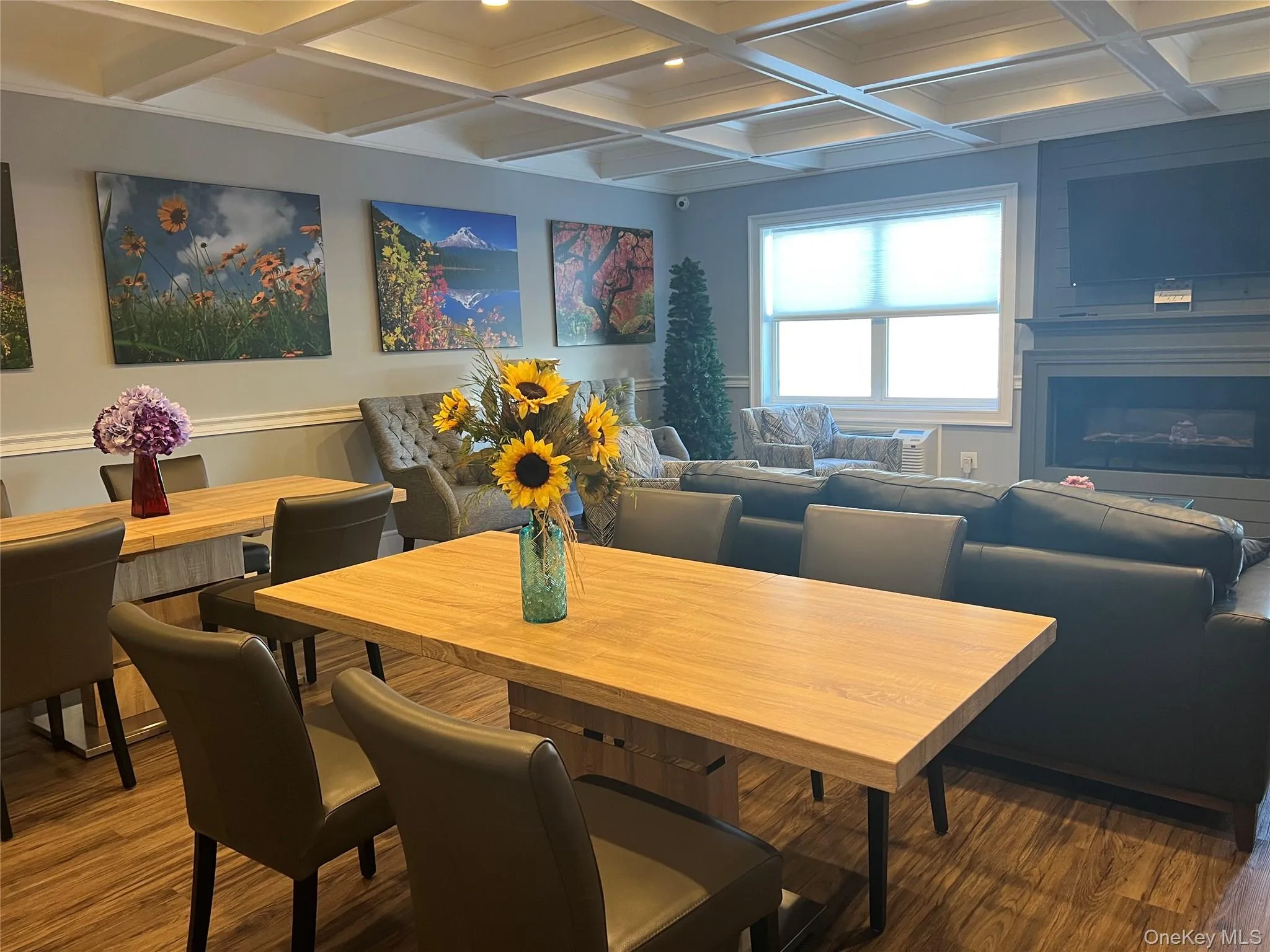 Dining space with coffered ceiling, dark wood-style floors, beam ceiling, and recessed lighting Dining space with coffered ceiling, dark wood-style floors, beam ceiling, and recessed lighting