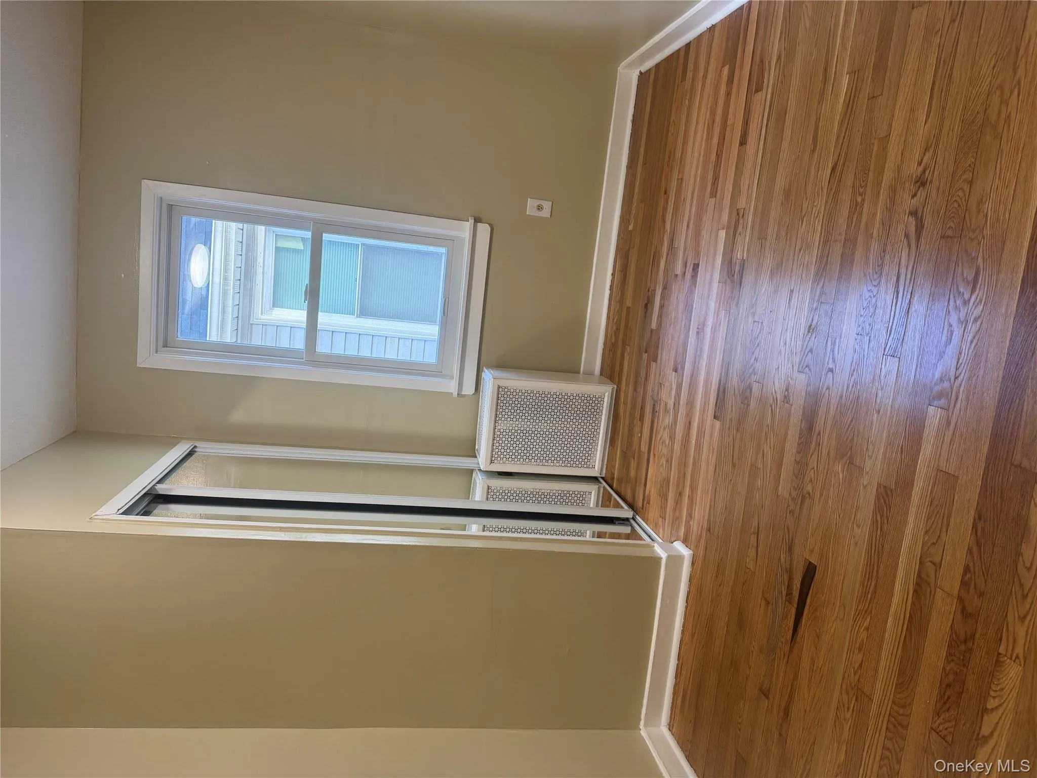 Unfurnished bedroom with hardwood / wood-style floors and a closet Unfurnished bedroom with hardwood / wood-style floors and a closet