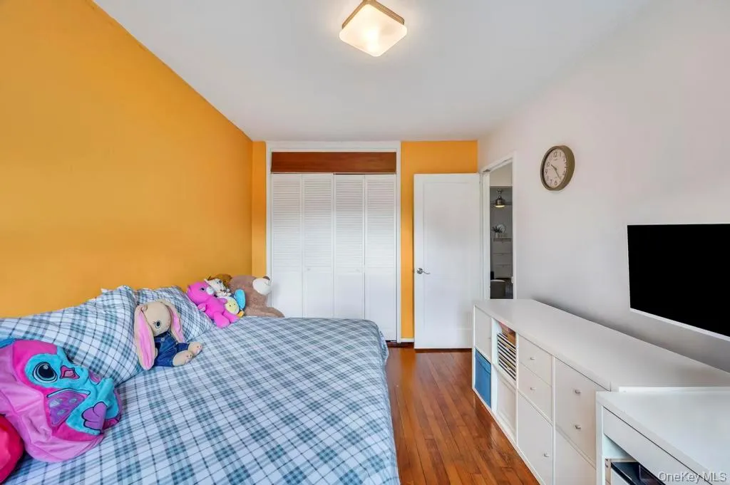 Bedroom with dark wood-type flooring and a closet Bedroom with dark wood-type flooring and a closet