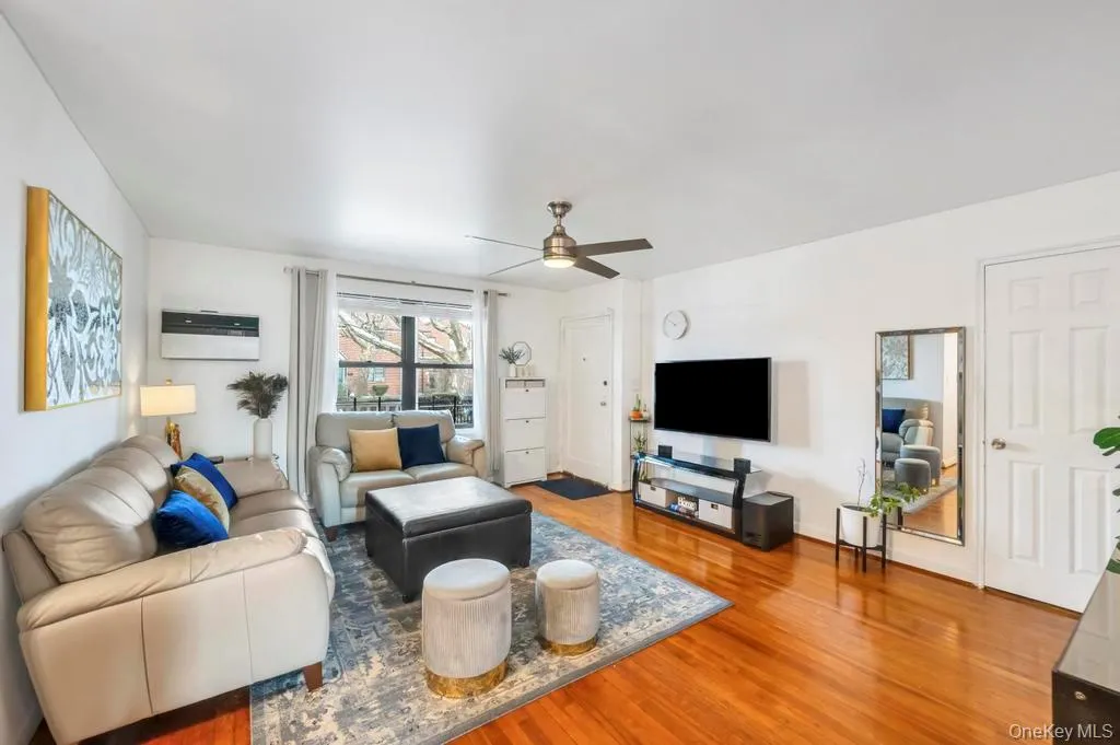 Living room featuring light wood-style floors and ceiling fan Living room featuring light wood-style floors and ceiling fan