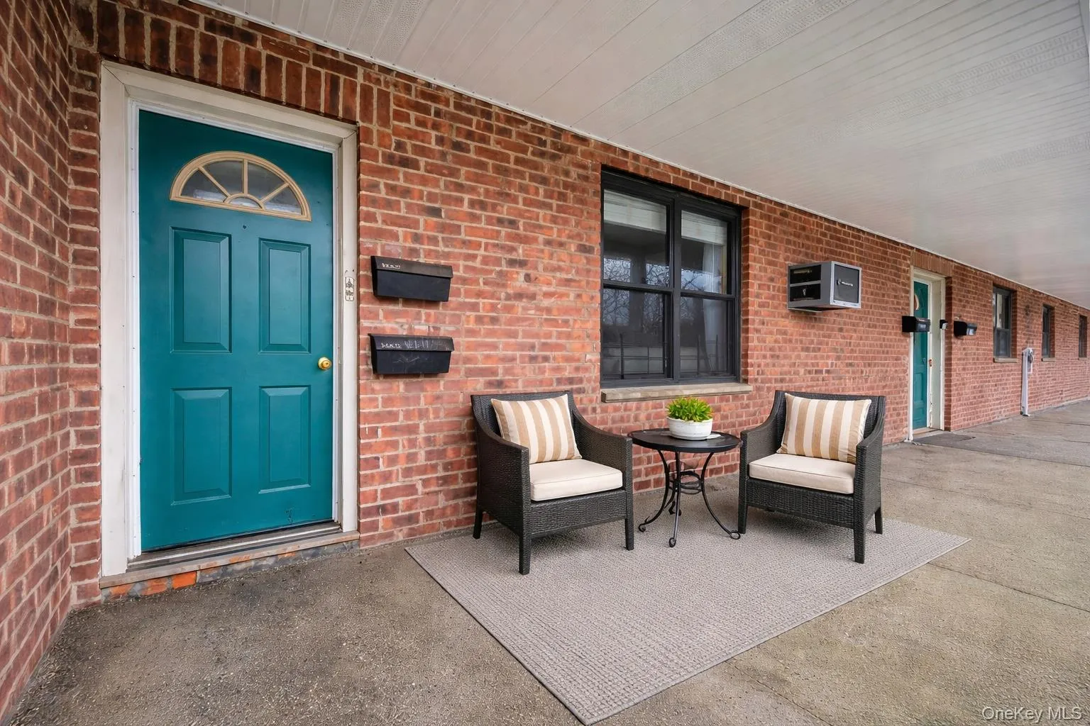 Entrance to property featuring brick siding and a patio area Entrance to property featuring brick siding and a patio area