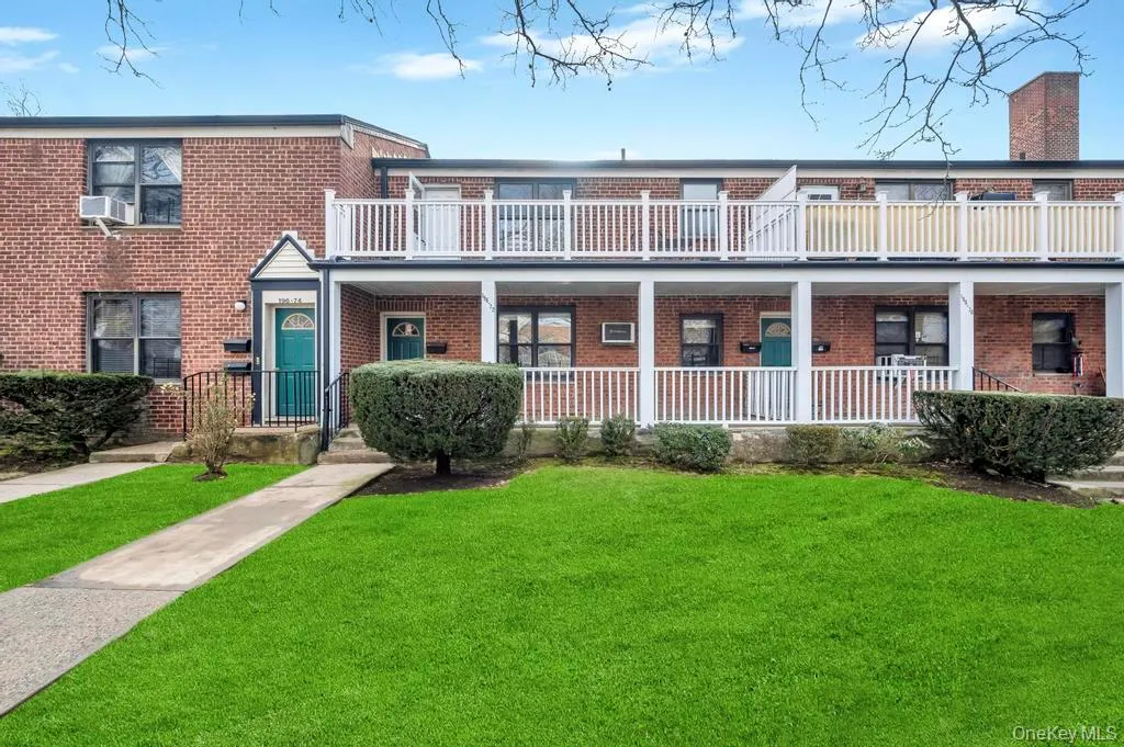 Traditional-style house featuring brick siding, a front lawn, covered porch, and a balcony Traditional-style house featuring brick siding, a front lawn, covered porch, and a balcony