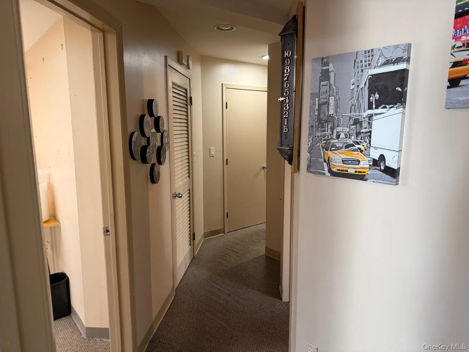 Hallway with dark colored carpet and recessed lighting Hallway with dark colored carpet and recessed lighting