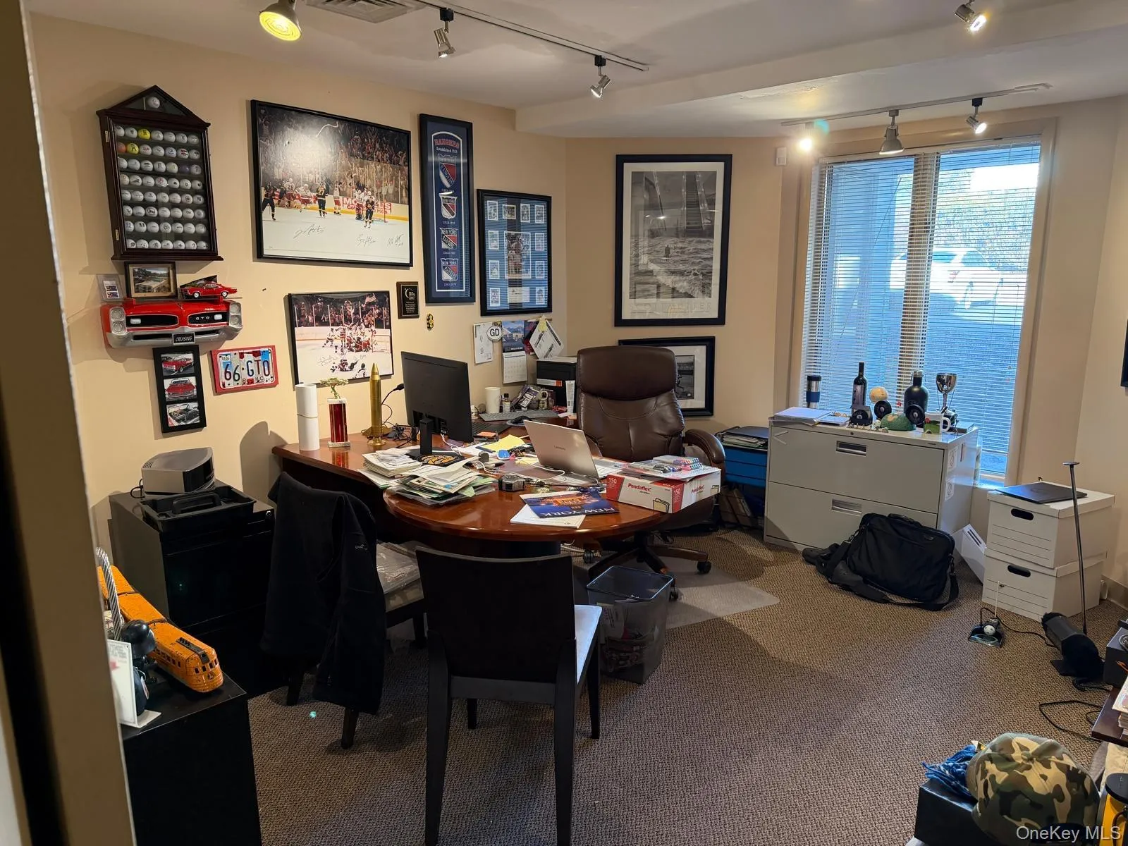 Office space with track lighting and carpet Office space with track lighting and carpet