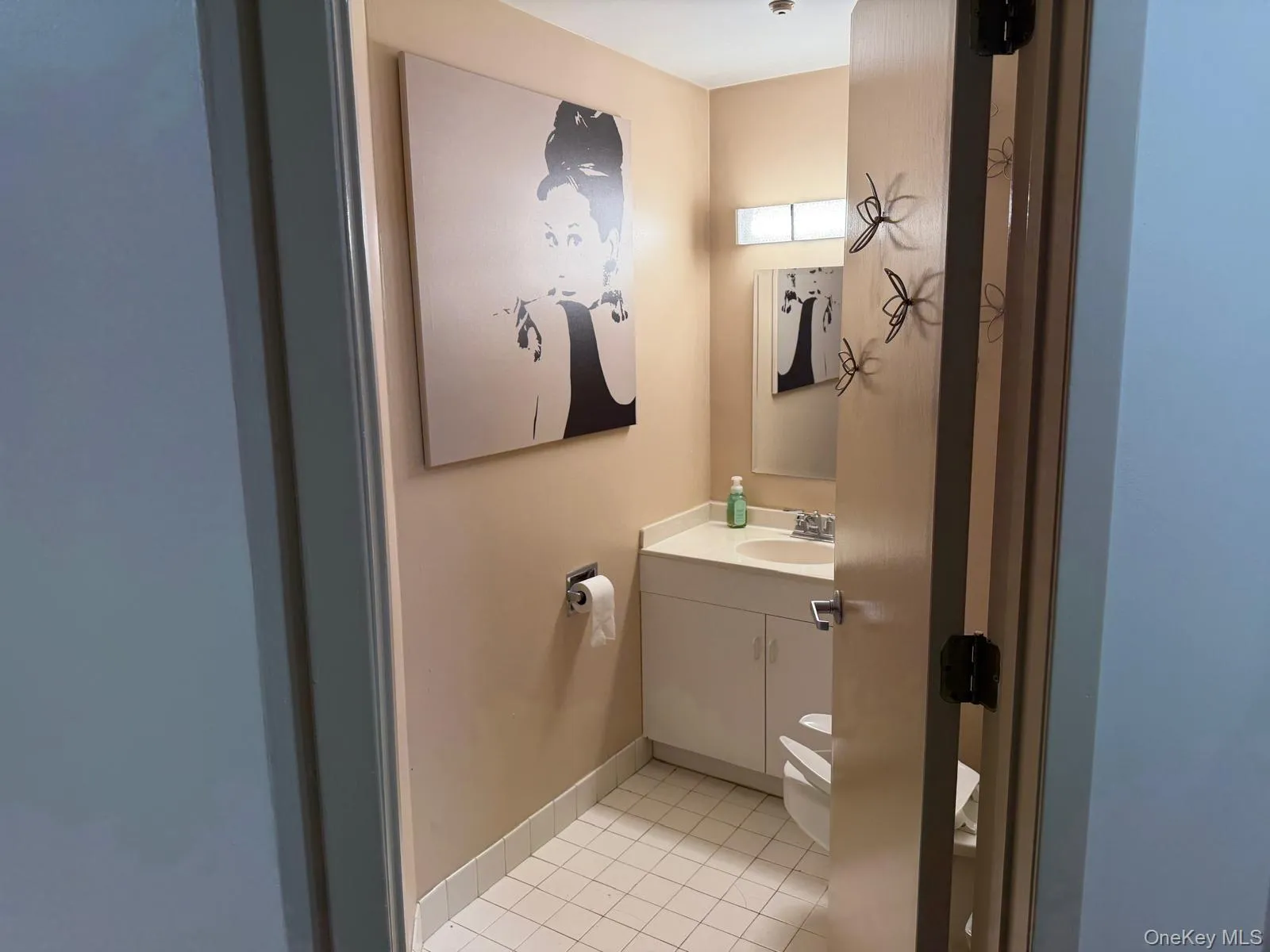 Bathroom featuring vanity and light tile patterned floors Bathroom featuring vanity and light tile patterned floors