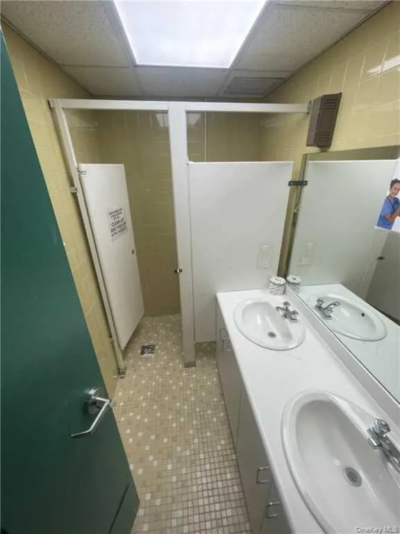 Full bathroom featuring double vanity and a paneled ceiling Full bathroom featuring double vanity and a paneled ceiling