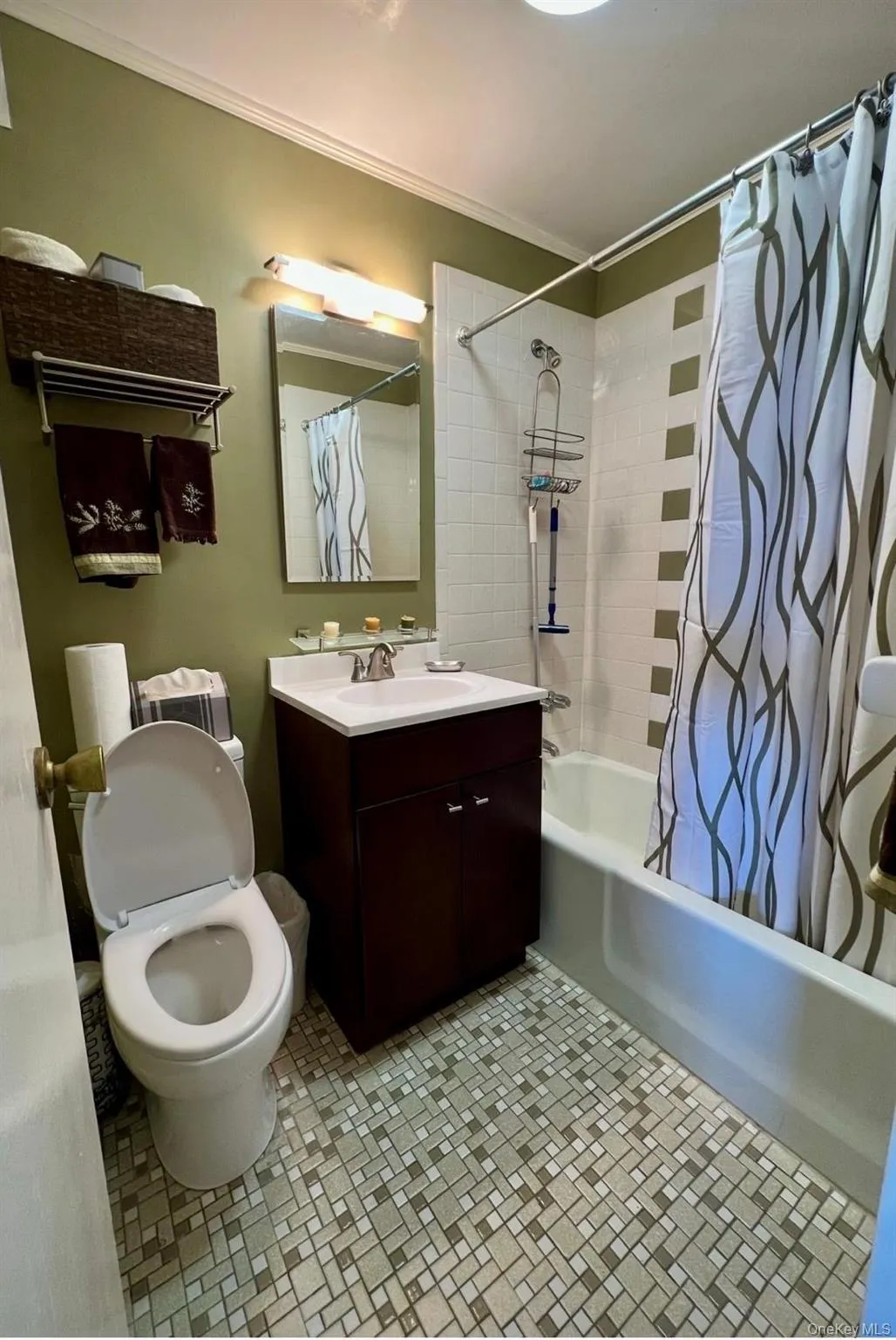 Bathroom with shower / bath combo with shower curtain, vanity, and crown molding Bathroom with shower / bath combo with shower curtain, vanity, and crown molding