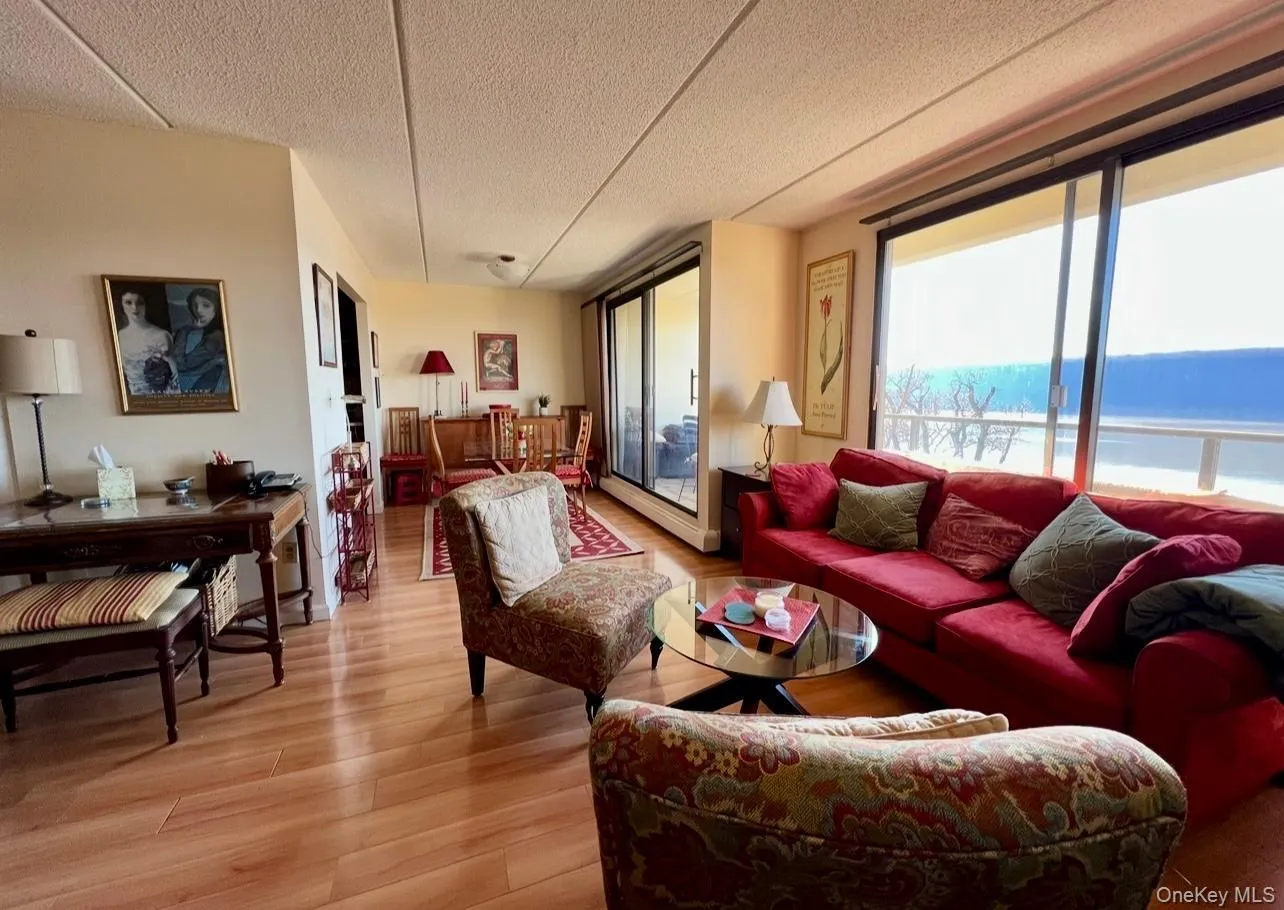 Living area with light wood-type flooring and a baseboard heating unit Living area with light wood-type flooring and a baseboard heating unit