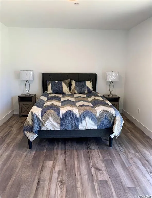 Bedroom featuring wood finished floors Bedroom featuring wood finished floors