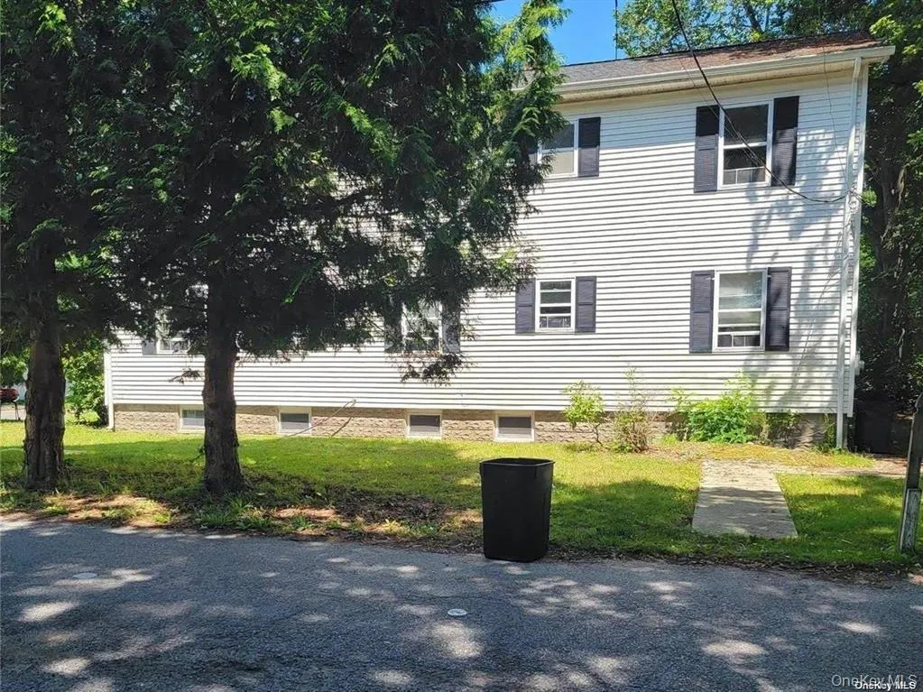 View of side of home featuring a yard View of side of home featuring a yard