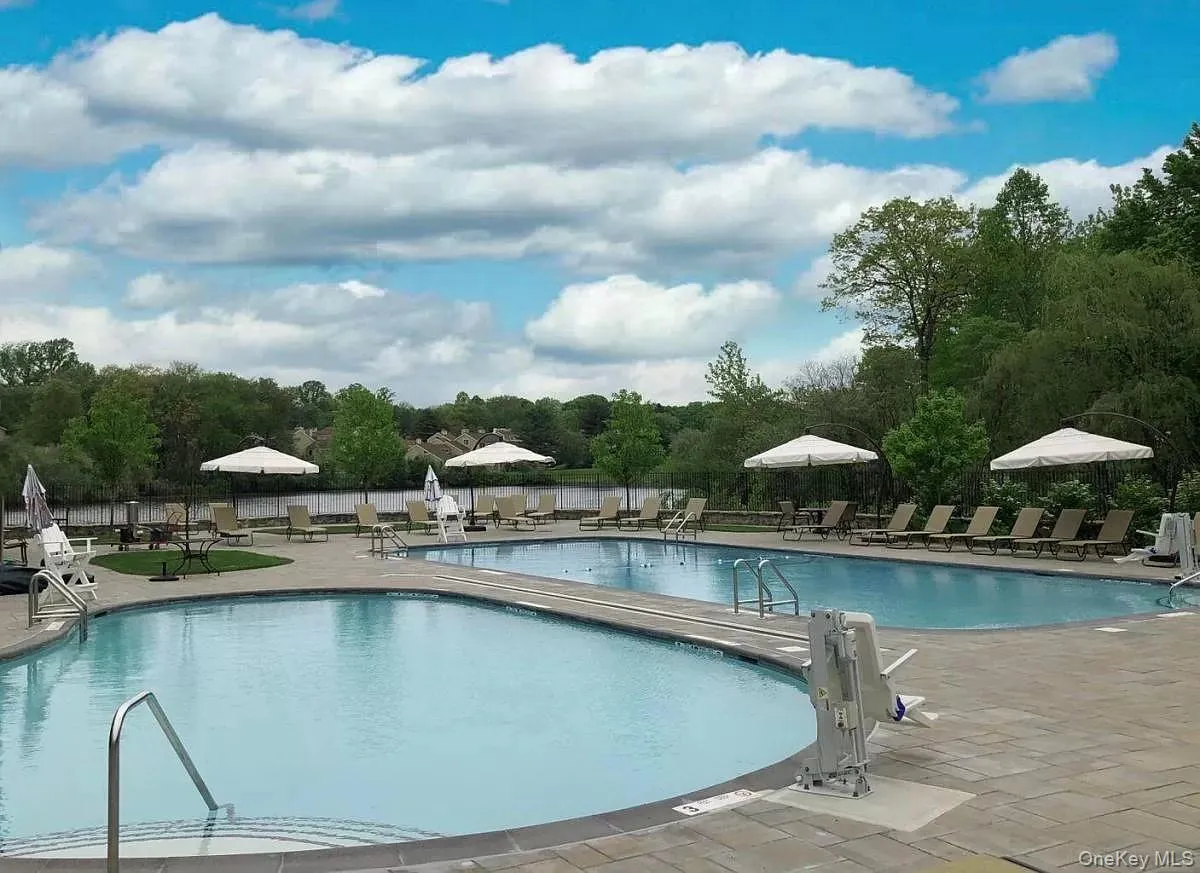 Community pool with a patio area Community pool with a patio area