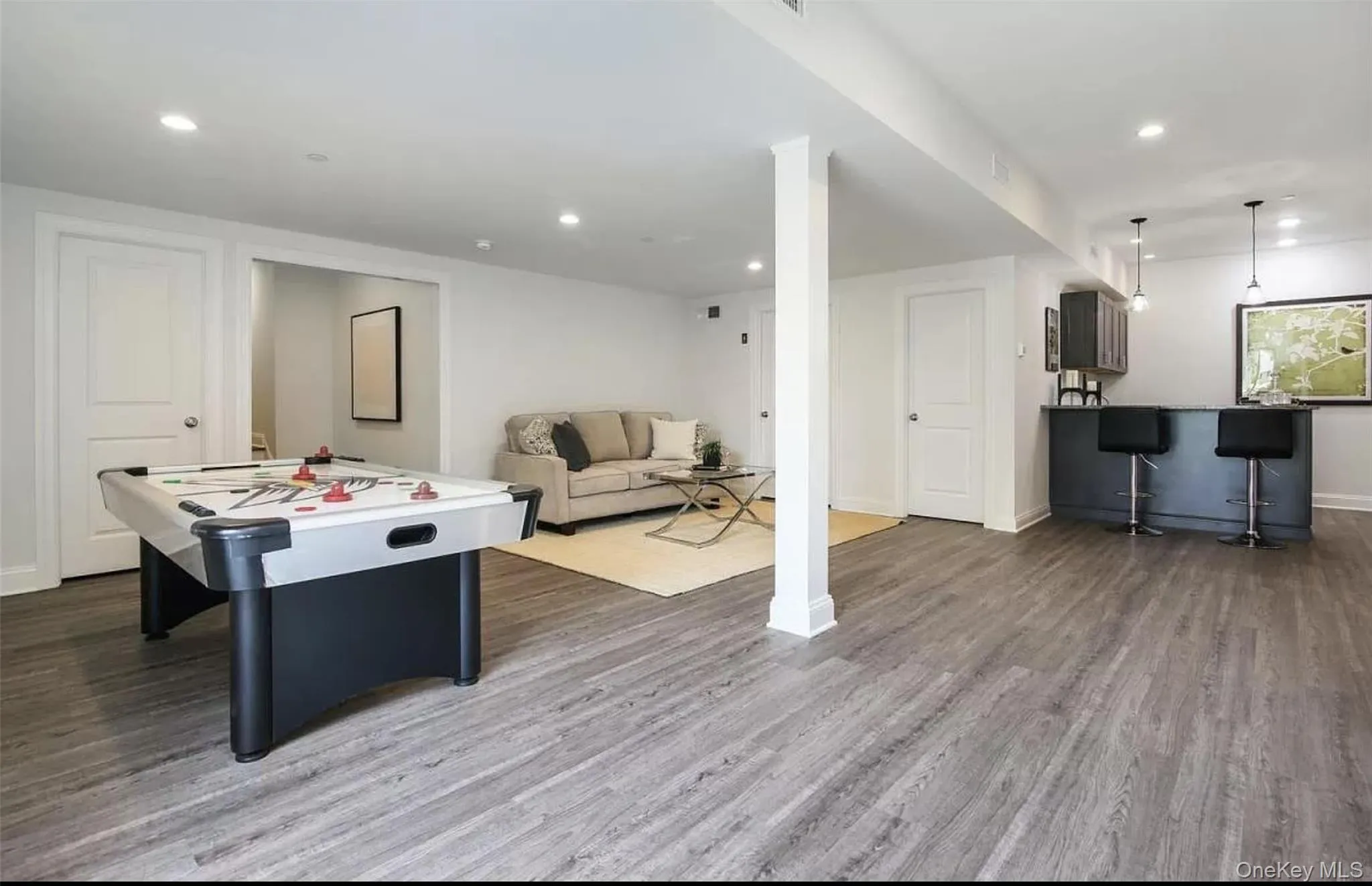 Game room with recessed lighting and dark wood-type flooring Game room with recessed lighting and dark wood-type flooring