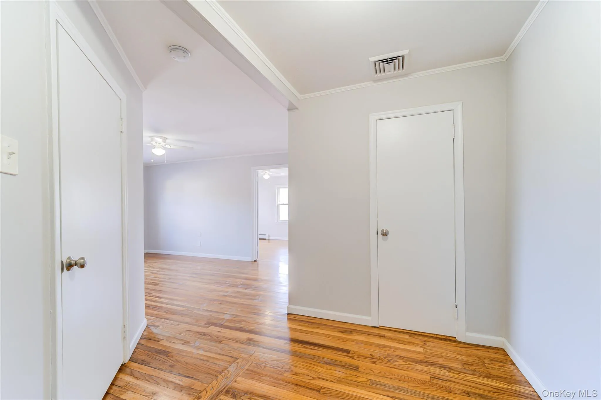Entry to Unit C featuring light wood finished floors and crown molding Entry to Unit C featuring light wood finished floors and crown molding