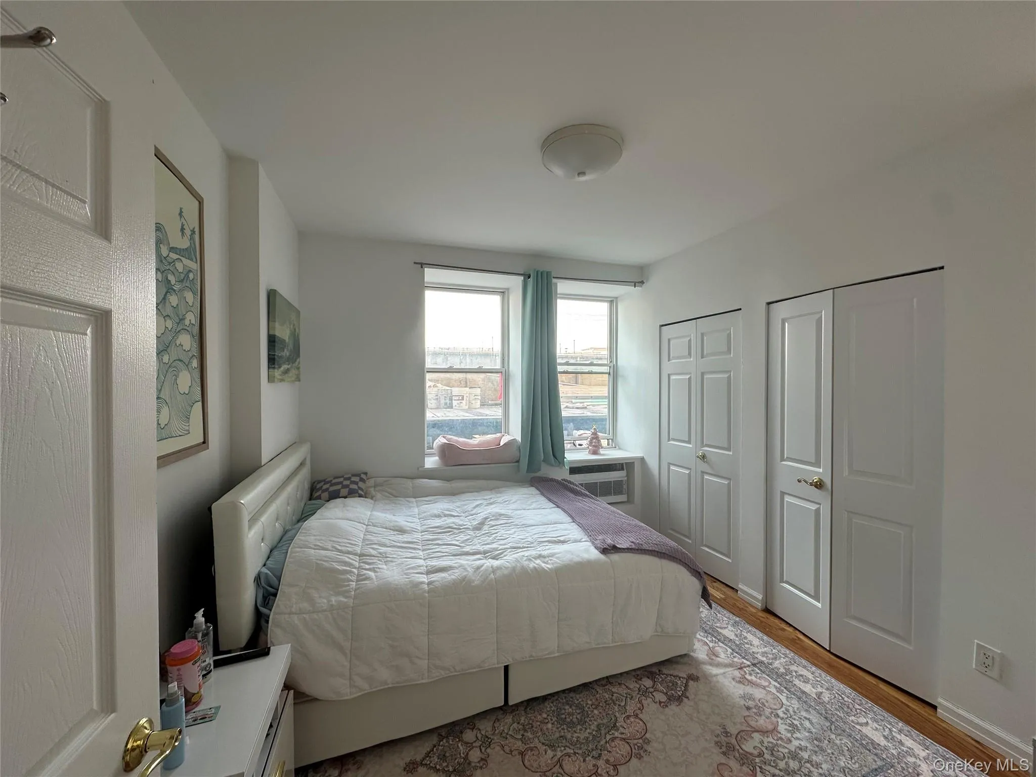 Bedroom with two closets and wood finished floors Bedroom with two closets and wood finished floors