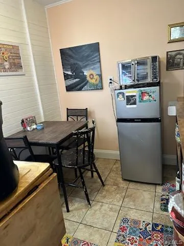 Dining space featuring wooden walls and baseboards Dining space featuring wooden walls and baseboards