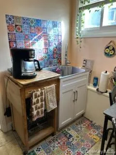 Bar with white cabinets and light countertops Bar with white cabinets and light countertops