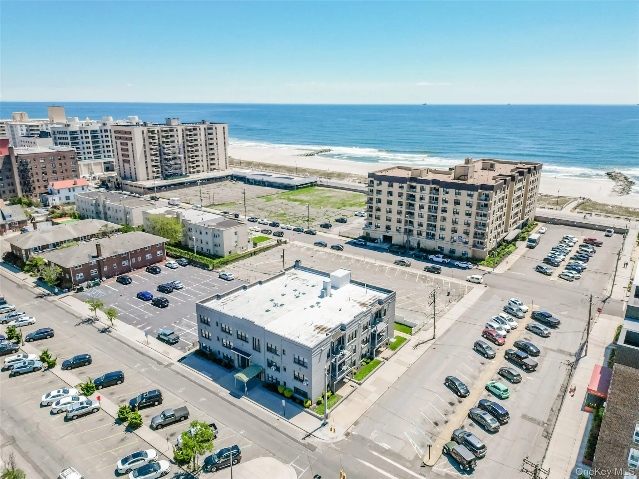 Bird's eye view of a nearby body of water and apartment complex / building Bird's eye view of a nearby body of water and apartment complex / building