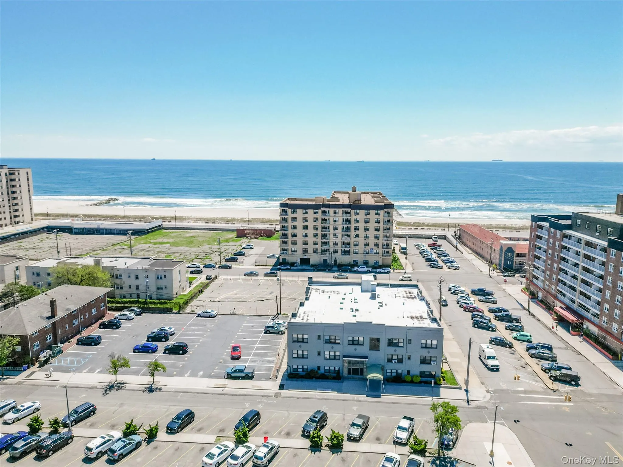 Aerial view of a nearby body of water and apartment complex / building Aerial view of a nearby body of water and apartment complex / building