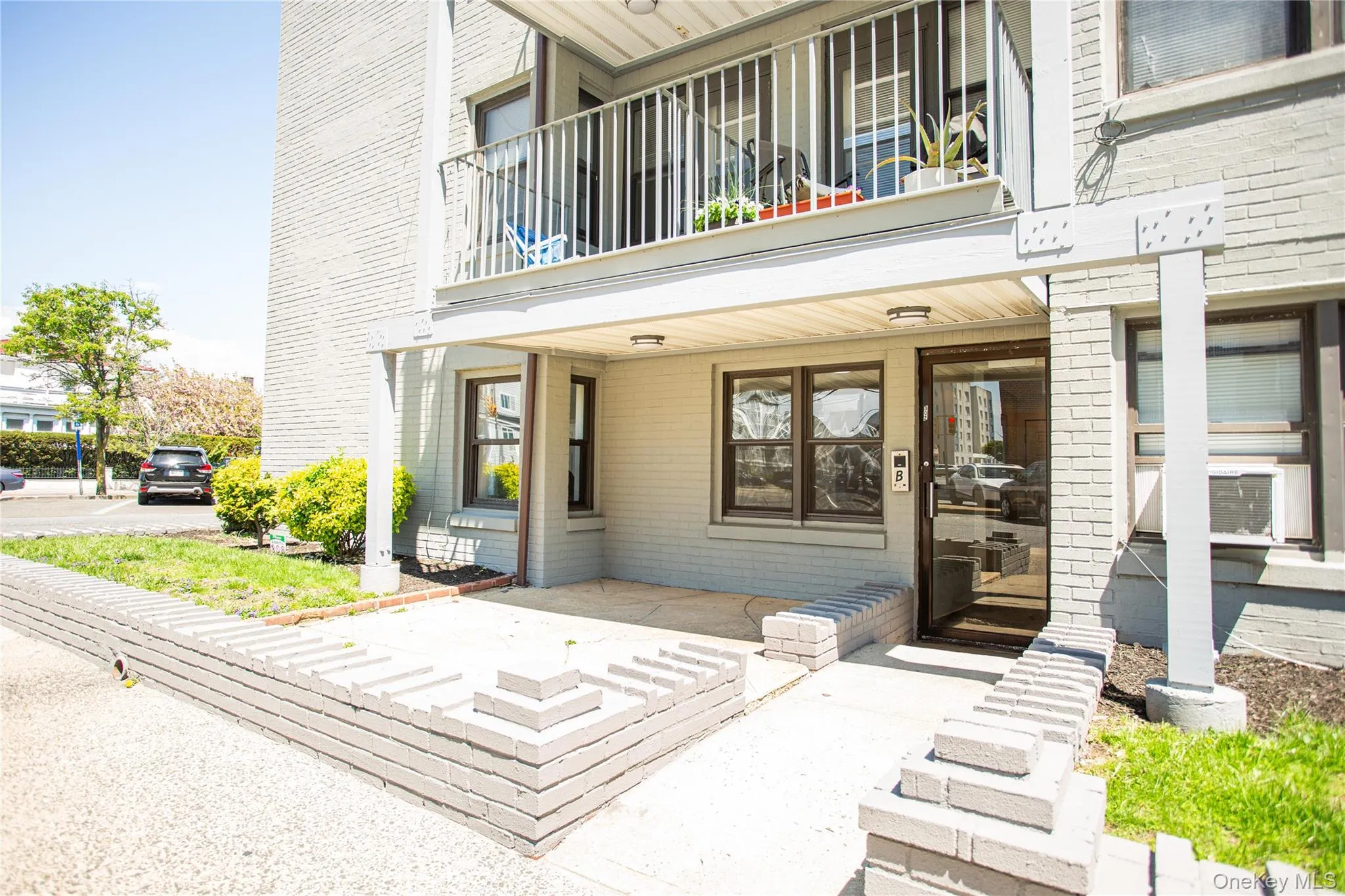Entrance to property with a balcony, covered porch, and cooling unit Entrance to property with a balcony, covered porch, and cooling unit